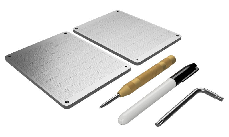 Coinplate Alpha box contents including plates, punch tool, and accessories